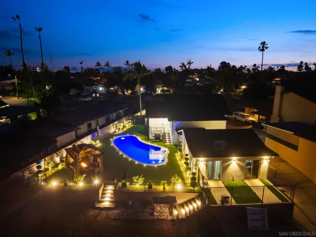 a aerial view of a house with swimming pool garden and patio