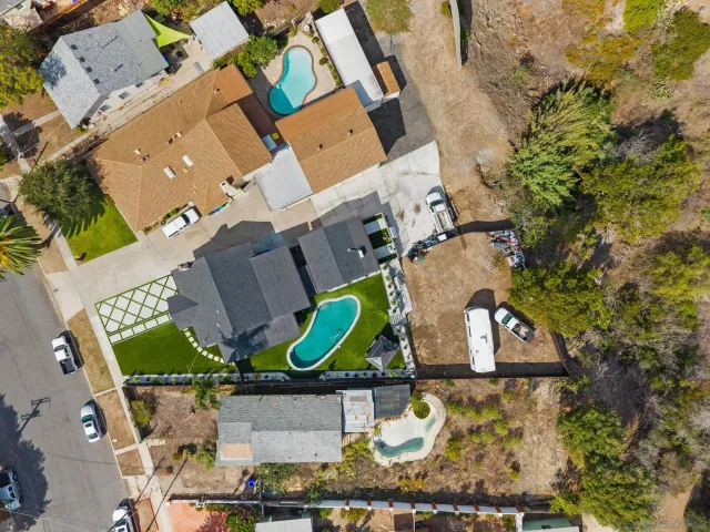 a view of a house with backyard and swimming pool