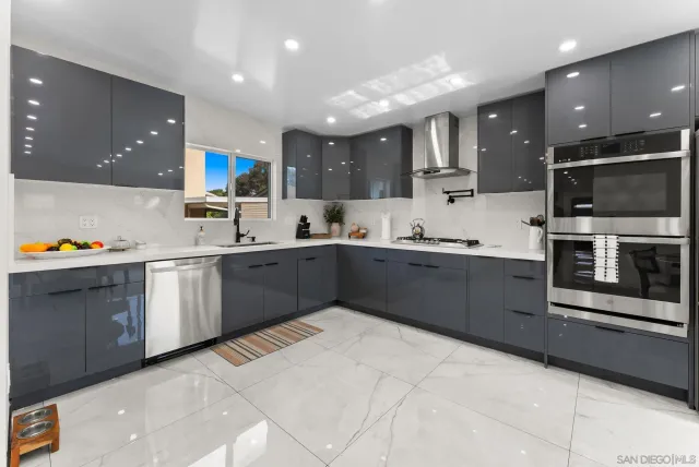 a kitchen with stainless steel appliances a refrigerator stove and microwave