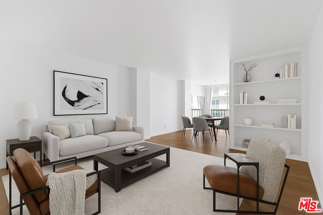 10747 Wilshire Boulevard, Unit 805 Los Angeles, CA 90024 - Photo 1 of 14 a living room with furniture and a large window with wooden floor
