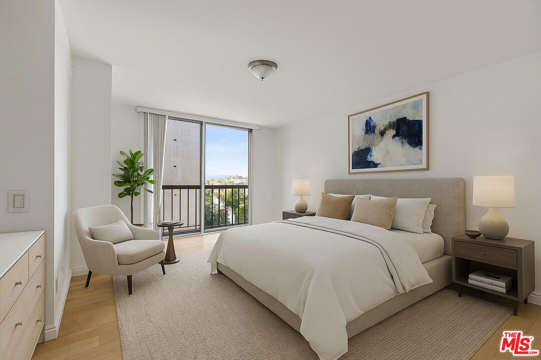 10747 Wilshire Boulevard, Unit 805 Los Angeles, CA 90024 - Photo 5 of 14 a bedroom with a bed a couch and potted plant on the dresser
