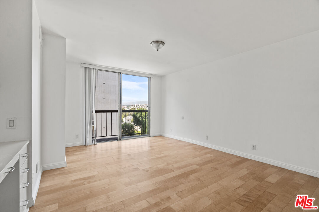 10747 Wilshire Boulevard, Unit 805 Los Angeles, CA 90024 - Photo 6 of 14 a view of an empty room with a window