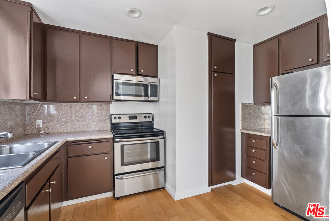 10747 Wilshire Boulevard, Unit 805 Los Angeles, CA 90024 - Photo 8 of 14 a kitchen with a sink and a refrigerator