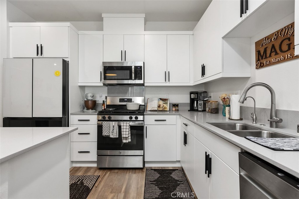 344 Zest Lane Fallbrook, CA 92028 - Photo 13 of 36 a kitchen with stainless steel appliances granite countertop a sink and white cabinets