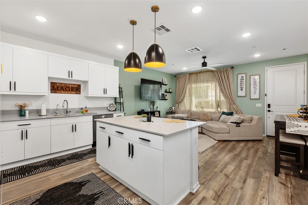 344 Zest Lane Fallbrook, CA 92028 - Photo 14 of 36 a kitchen that has a lot of cabinets in it and wooden floors