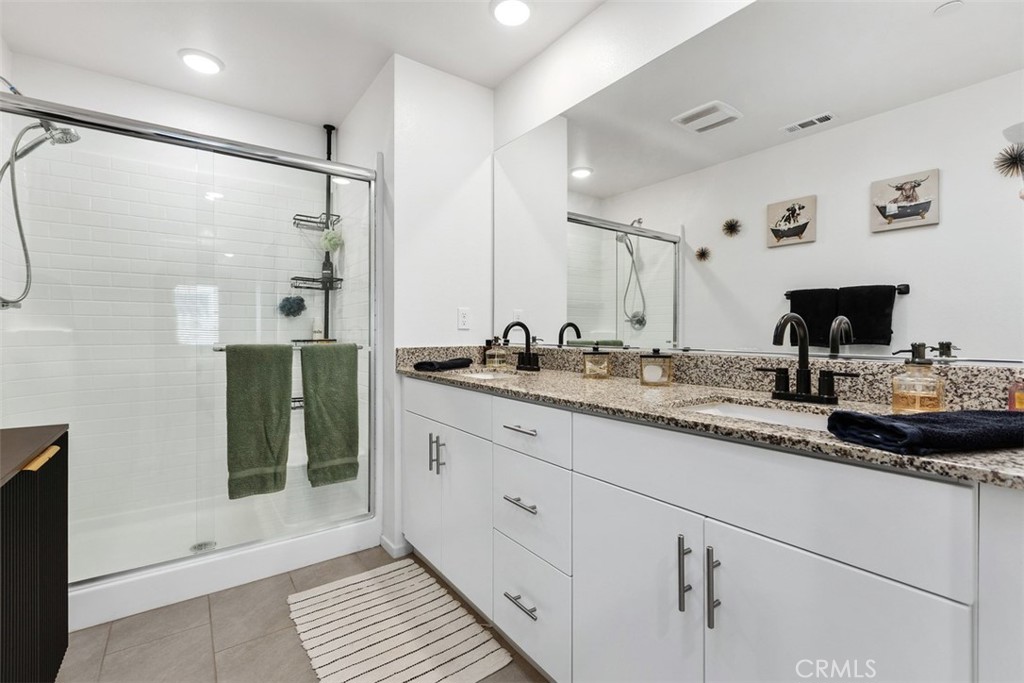 344 Zest Lane Fallbrook, CA 92028 - Photo 22 of 36 a bathroom with double vanity and a shower