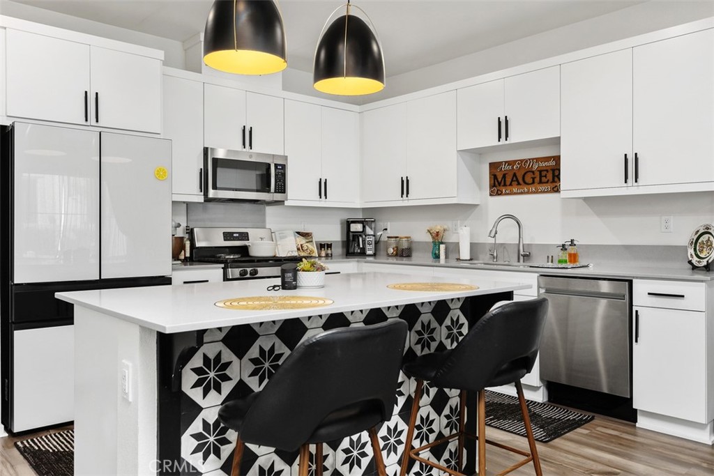 344 Zest Lane Fallbrook, CA 92028 - Photo 10 of 36 a kitchen with stainless steel appliances granite countertop a sink dishwasher a stove a refrigerator a microwave oven with granite countertops and cabinets