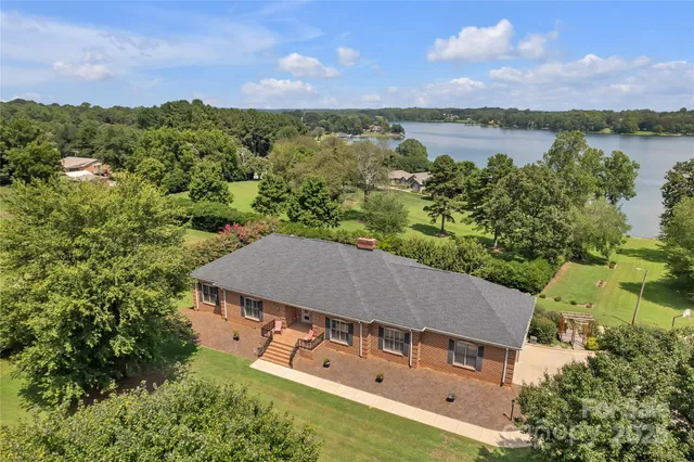 an aerial view of a house with a lake view