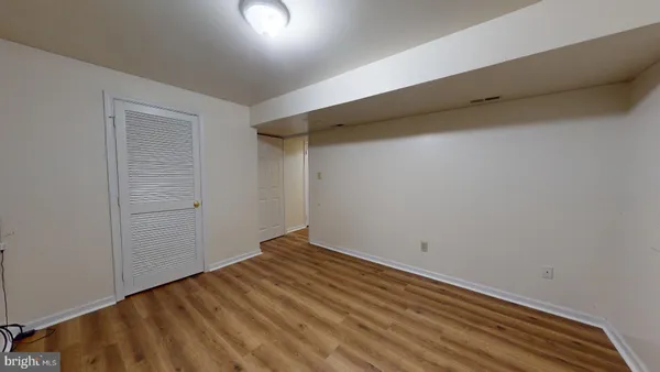 a view of room with wooden floor