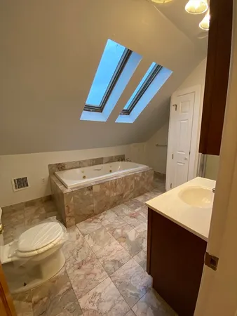 a bathroom with a sink toilet and mirror