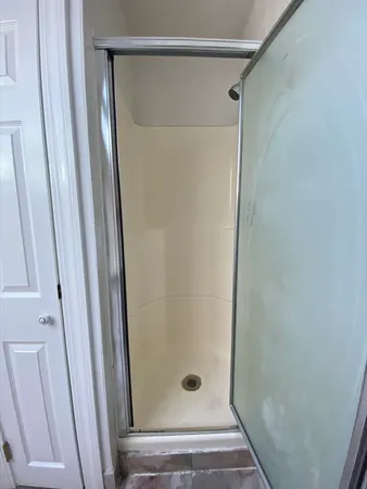 a bathroom with a glass shower door