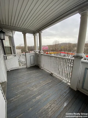 a view of a balcony with furniture