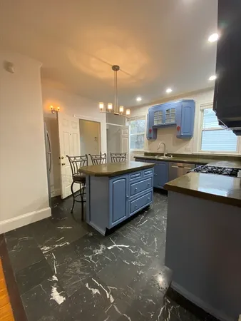 a kitchen with a sink cabinets and window