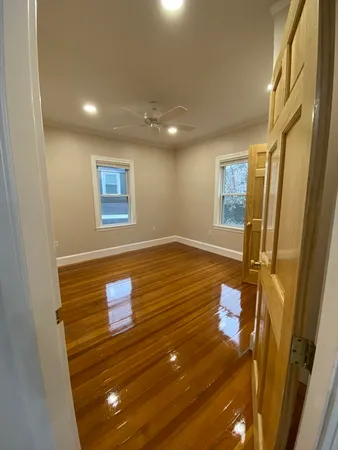 a view of hallway with wooden floor