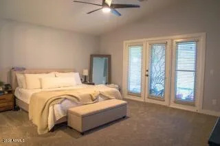 a spacious bedroom with a bed and glass windows