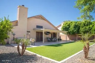 a view of a backyard with sitting area