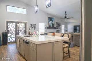 a kitchen with stainless steel appliances granite countertop a sink a stove and a refrigerator