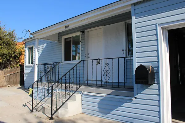 a view of a deck with wooden floor and a potted plant