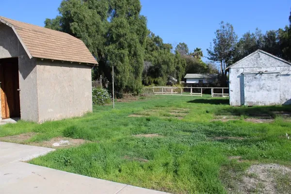 a backyard of a house with table and chairs