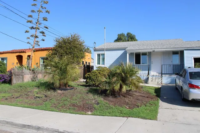 a view of a house with a yard and plants