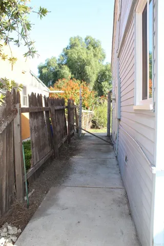 a view of a pathway of a house with a yard