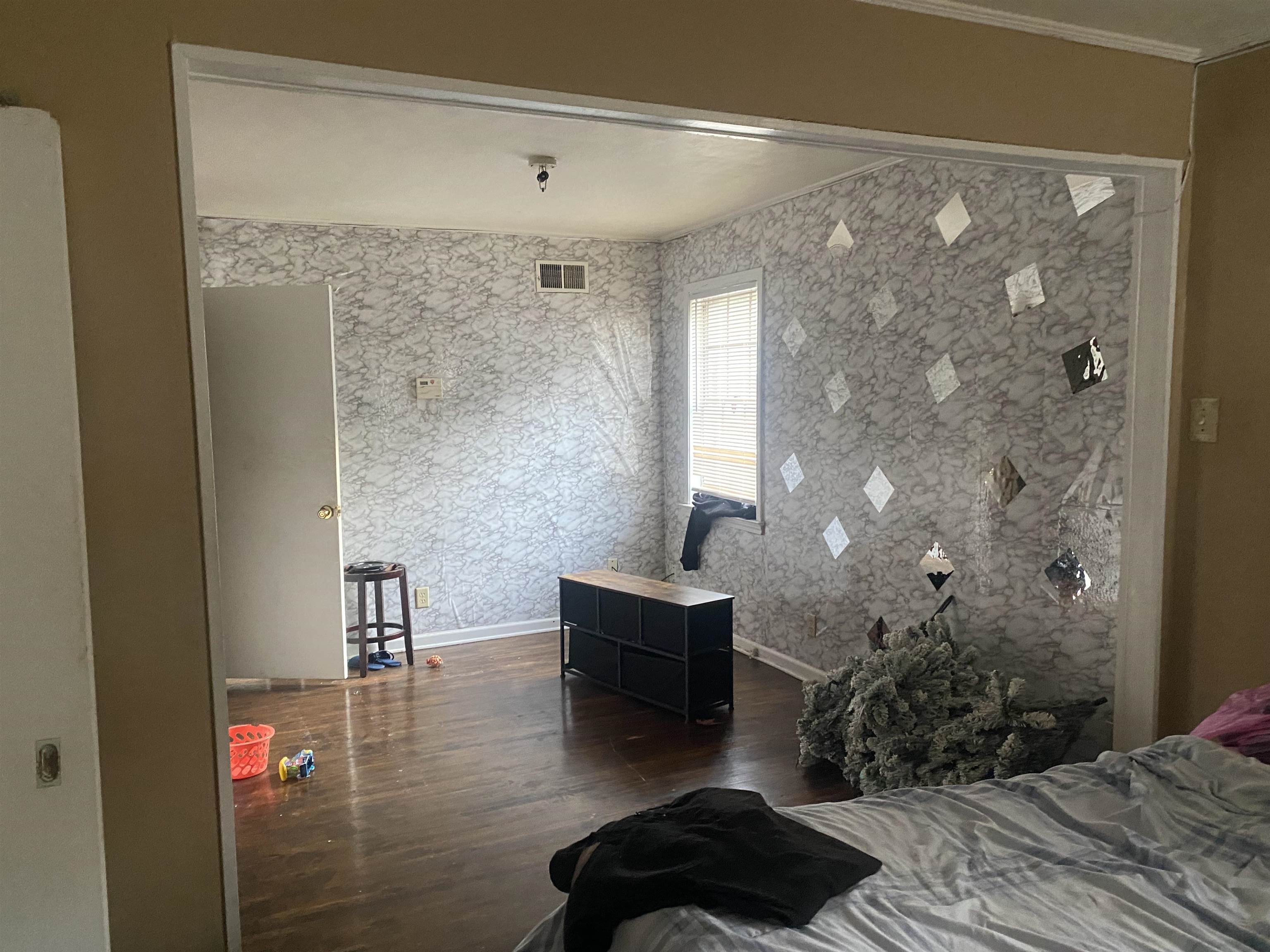 5466 Cottonwood Road Memphis, TN 38115 - Photo 11 of 16 a bedroom with a bed and a chandelier