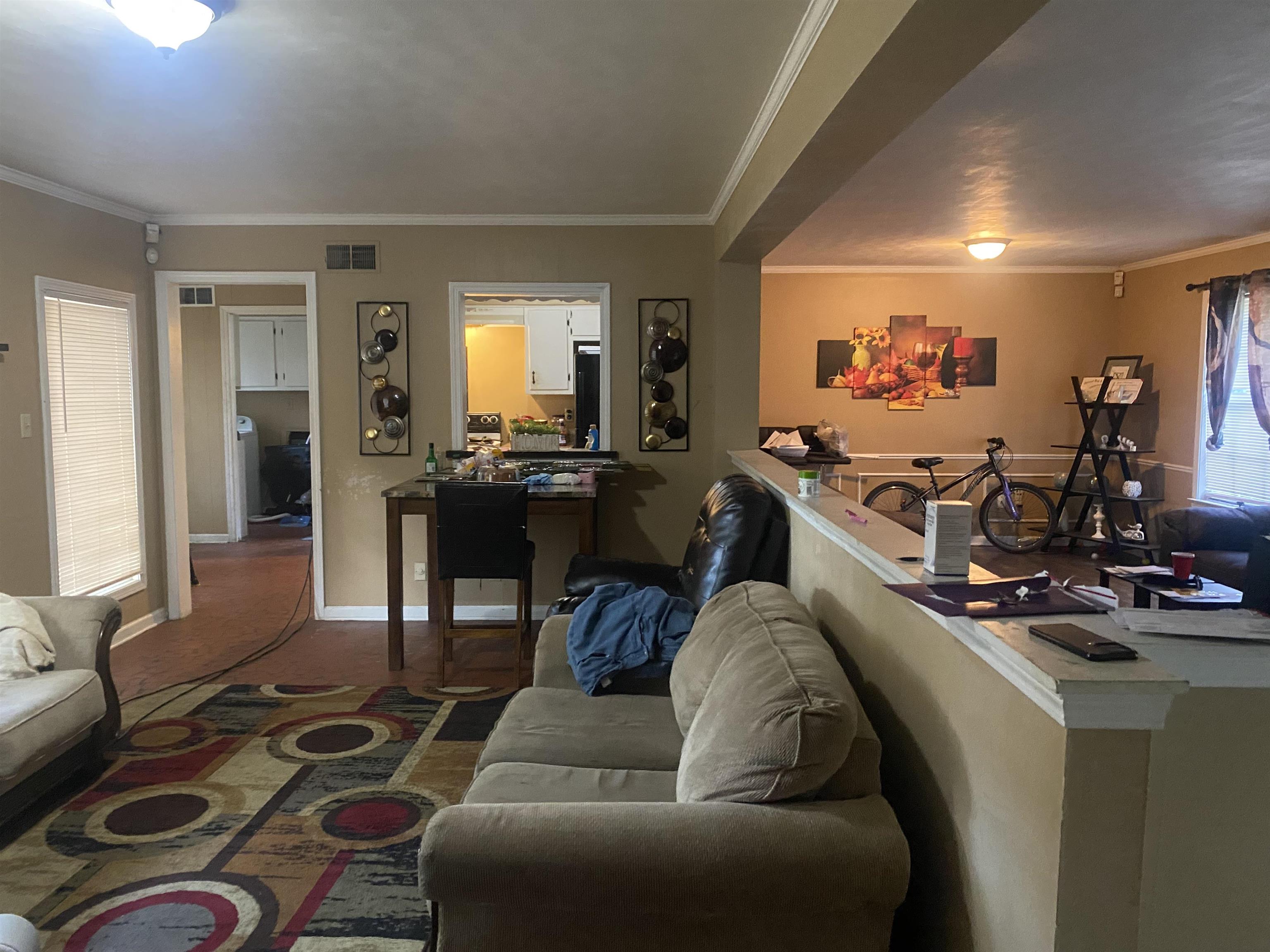 5466 Cottonwood Road Memphis, TN 38115 - Photo 2 of 16 a living room with furniture a flat screen tv and a large window