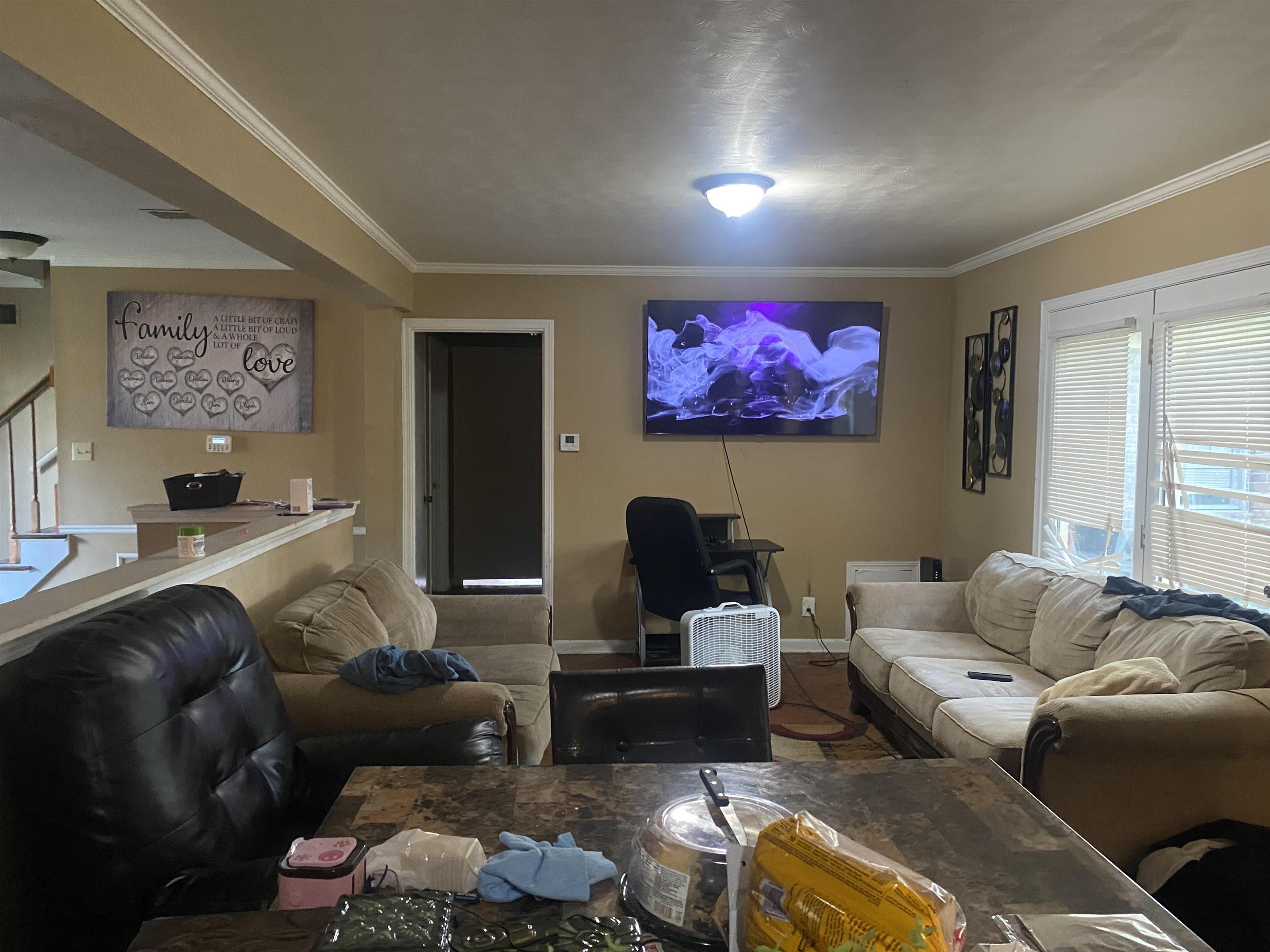 5466 Cottonwood Road Memphis, TN 38115 - Photo 3 of 16 a living room with furniture and a flat screen tv