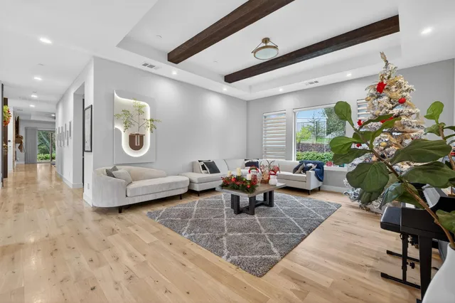 a living room with furniture and large windows