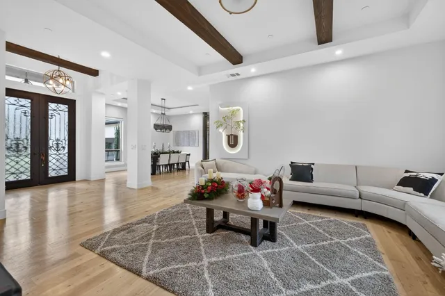 a living room with furniture fireplace and a large window
