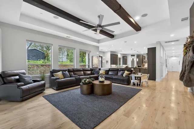 a large kitchen with a large counter top space appliances and cabinets