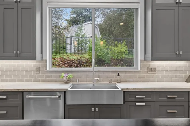 a room with furniture a flat screen tv and a window