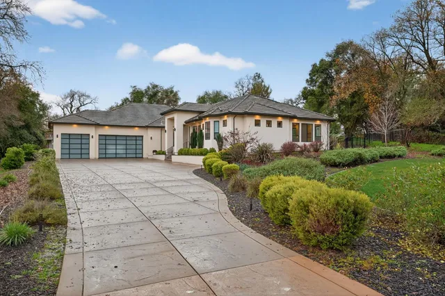 a view of a building with a yard and potted plants