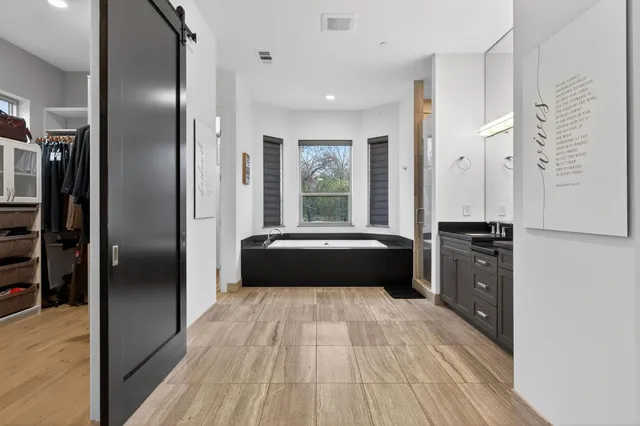an aerial view of a house with a yard and trees all around