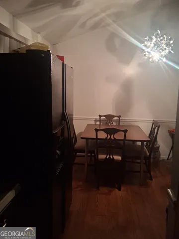 a view of a dining room with furniture and chandelier