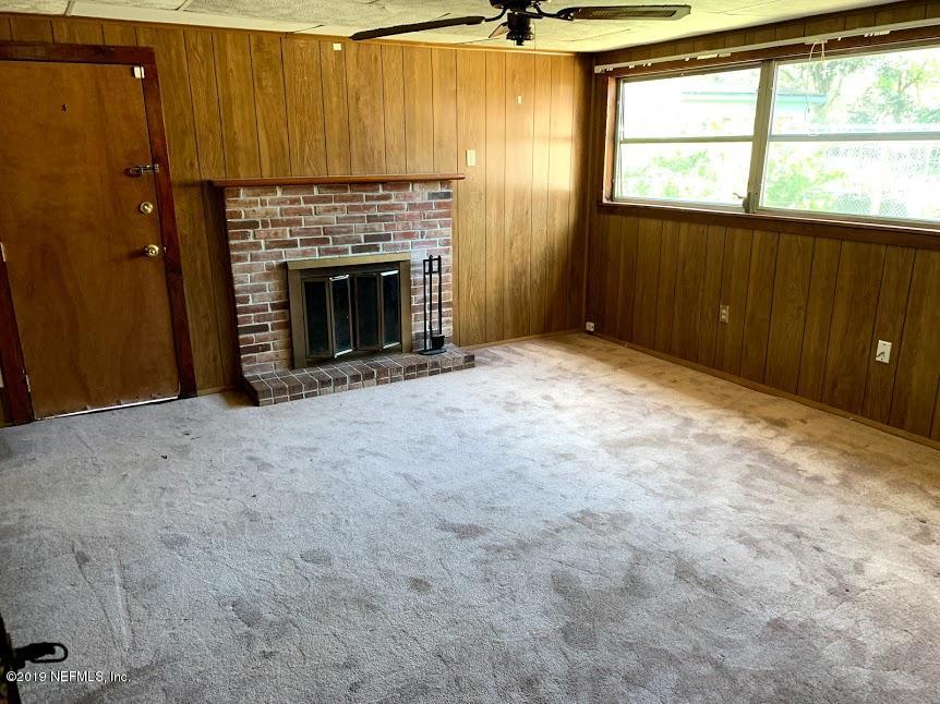 6744 Gamewell Road Jacksonville, FL 32211 - Photo 5 of 14 an empty room with windows and fireplace