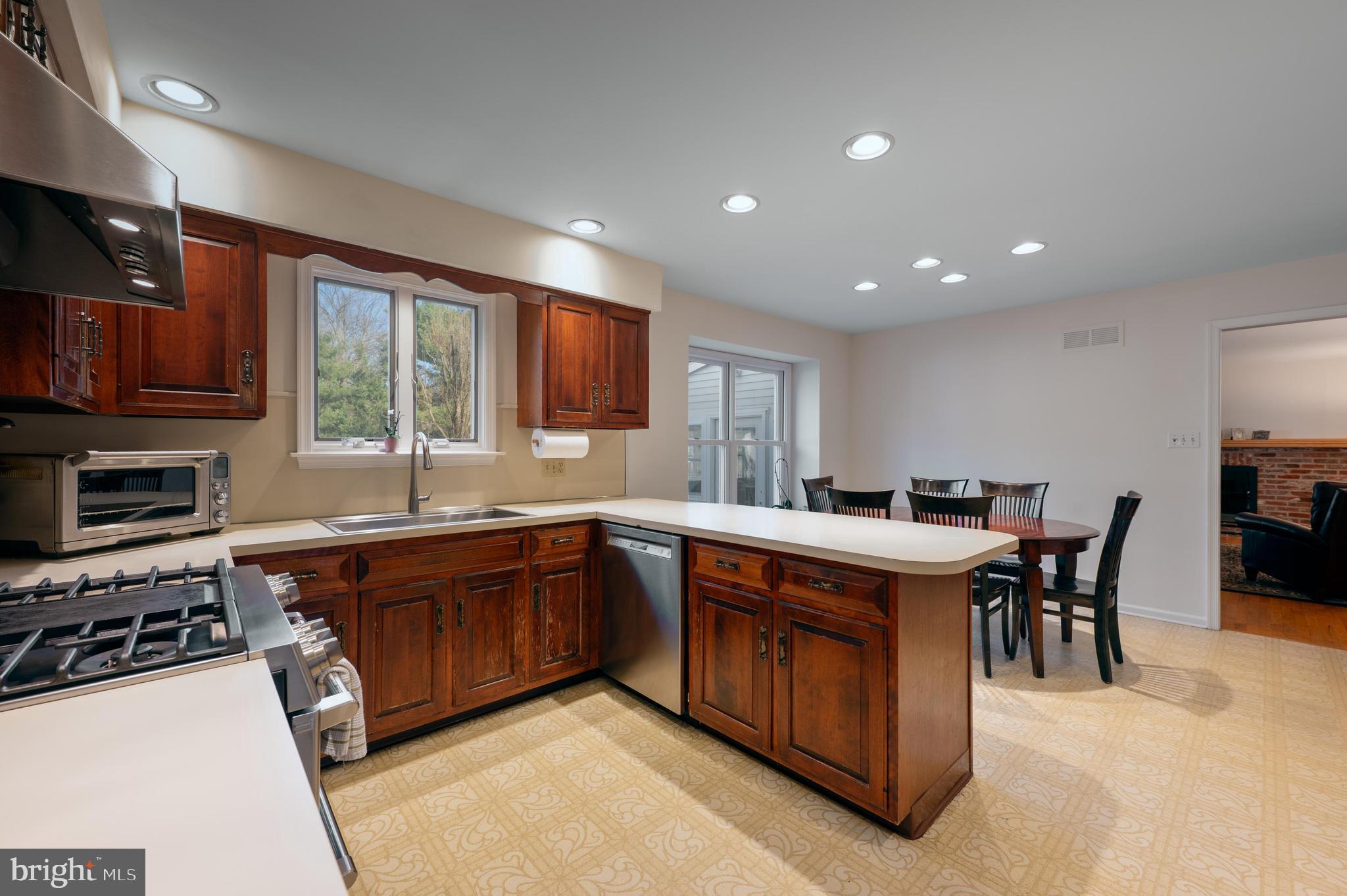 596 Sentinel Road Moorestown, NJ 08057 - Photo 8 of 31 a kitchen with stainless steel appliances granite countertop wooden cabinets a sink dishwasher a stove and a refrigerator with wooden floor