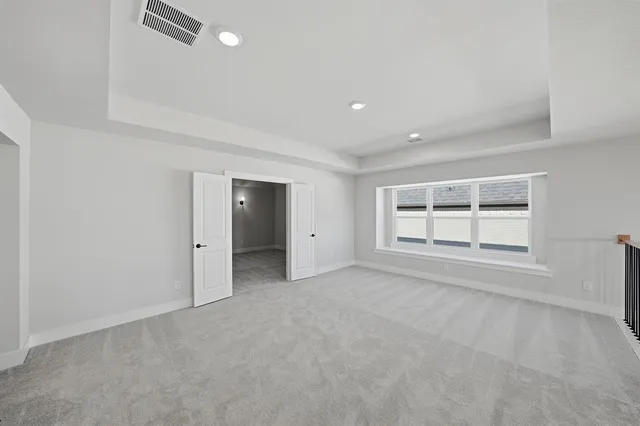 an empty room with windows and closet