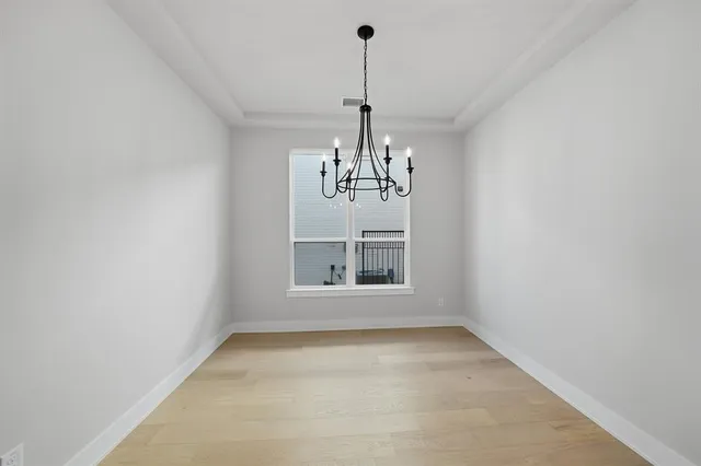 a view of a room with windows and chandelier
