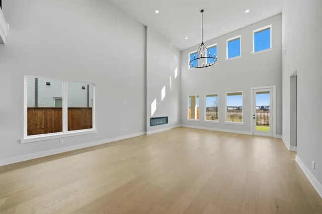 a view of an empty room with a window and fireplace