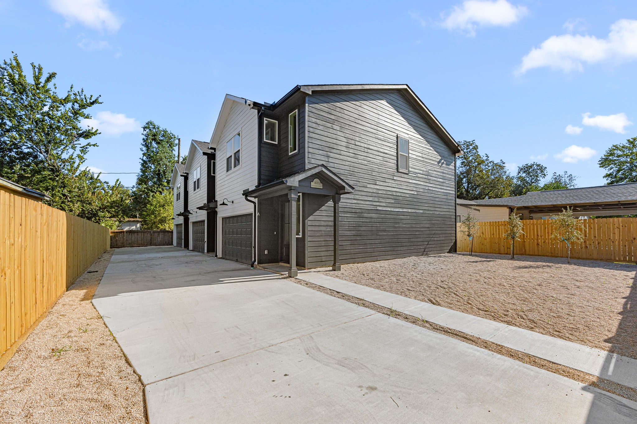 4611 Dewberry Street, Unit C Houston, TX 77021 - Photo 32 of 34 a front view of a house with a yard and garage