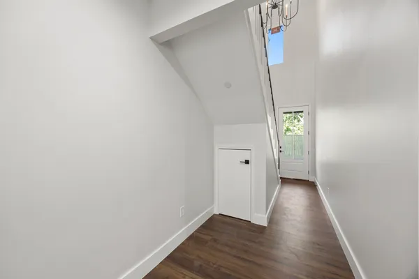 a view of a hallway with wooden floor