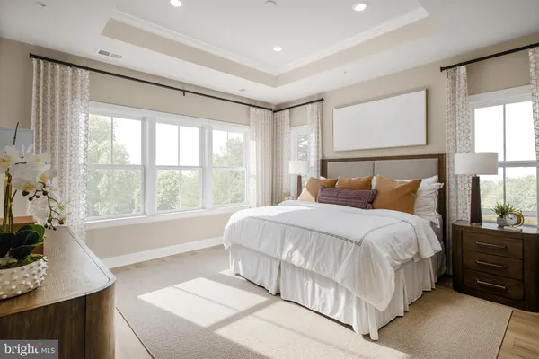 a large bed sitting in a bedroom next to a window