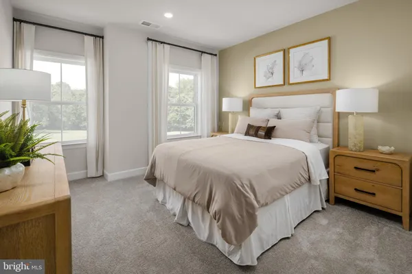 a spacious bedroom with a bed and a window