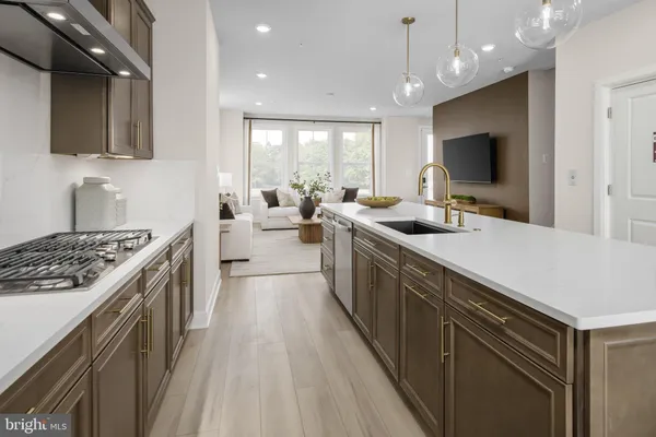 a kitchen with sink stove and refrigerator