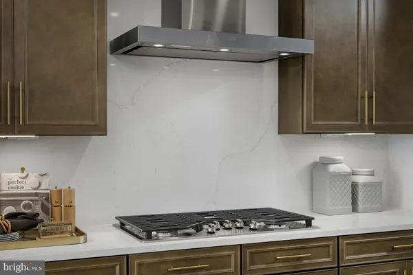 a stove top oven sitting inside of a kitchen