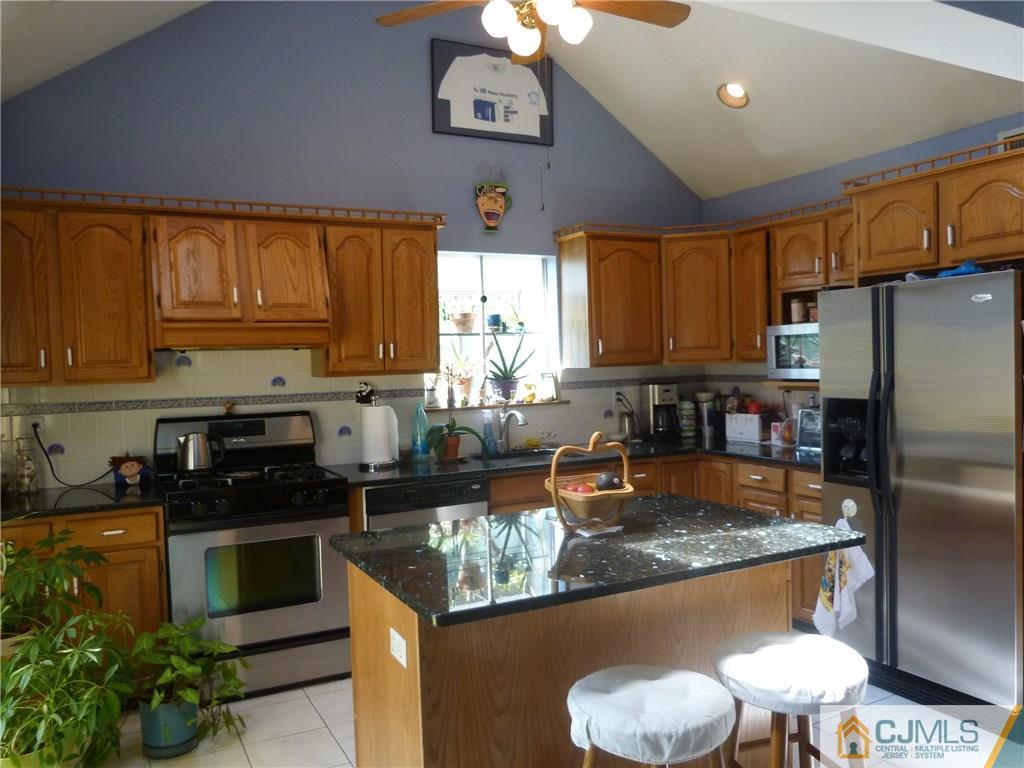 45 South Pennington Road New Brunswick, NJ 08901 - Photo 2 of 21 a kitchen with stainless steel appliances granite countertop a refrigerator a stove a sink and a microwave