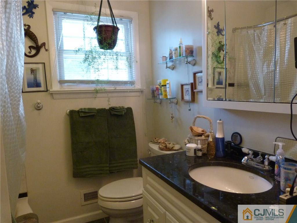 45 South Pennington Road New Brunswick, NJ 08901 - Photo 10 of 21 a bathroom with a granite countertop sink toilet and a mirror