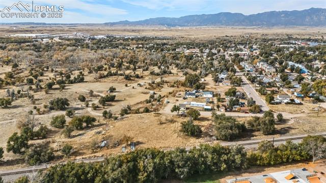 Aerial view of property and surrounding area with mountains