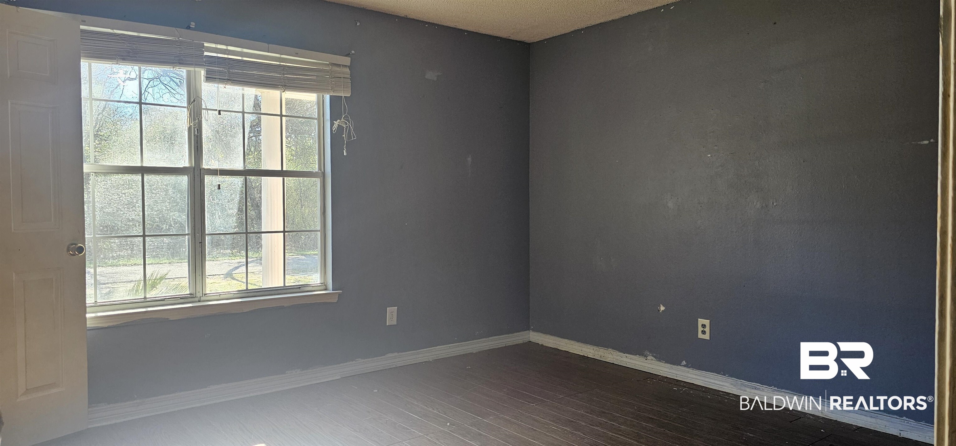 151 Bullard Street Atmore, AL 36502 - Photo 10 of 38 Empty room featuring baseboards and wood finished floors